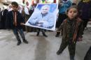 Kurdish children carry a picture of Abdullah Ocalan, jailed leader of the PKK, during celebration after it was reported that Kurdish forces took control of Kobani, in Aleppo