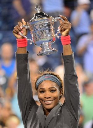 Serena Williams holds her trophy after defeating Victoria …