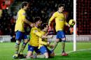 Arsenal's Santi Cazorla, third right, celebrates his goal with, from left, Mathieu Flamini, Olivier Giroud and Mesut Ozil during the English Premier League soccer match between Southampton and Arsenal at St Mary's stadium in Southampton, Tuesday, Jan. 28, 2014. (AP Photo/Matt Dunham)