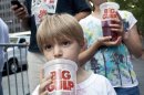 Benjamin Lesczynski takes a sip of a "Big Gulp" while protesting the proposed soda-ban in New York