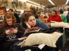 FILE - In this Nov. 25, 2011 file photo, Christy Embry, left, and Crystal Coleman wait in a long check out line during the Black Friday sale at Bass Pro Shops, in Memphis, Tenn. A new economic reality and new traditions gave birth to new types of shoppers this holiday 2011 season: the extreme discount bargain hunter, the Black Friday novice, the big returner and the selfish shopper. (AP Photo/The Commercial Appeal, Alan Spearman, file)