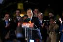 Hungary's PM Orban smiles as he addresses to supporters after partial results of parliamentary elections are announced in Budapest