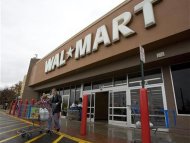 Shoppers cart their purchases from a Wal-Mart store in Alexandria