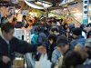 Japanese shoppers crowd a narrow street outside Tsukiji market in Tokyo