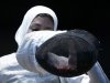 Egypt's El Gammal puts on her mask as she competes against Lebanon's Shaito during their women's Individual Foil round of 64 competition at the ExCel venue at the London 2012 Olympic Games