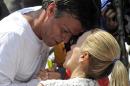 Leopoldo Lopez, an ardent opponent of Venezuela's socialist governmen, kisses his wife Lilian Tintori, during a demonstration before turning himself in to authorities, in Caracas on February 18, 2014