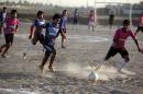 Iraqi youths play football in a working-class neighbourhood of Baghdad on July 4, 2013