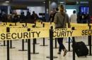 Passengers make their way through a security checkpoint at JFK International Airport in New York