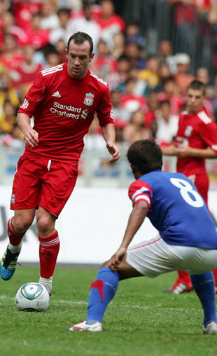 New Liverpool player Charlie Adam takes on an opposition player in the game. (Getty Images)