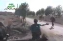 In this amateur video provided by a group which calls itself Ugarit News, Syrian rebels cross a road during a raid on the village of Hatla, Syria, Wednesday, June 12, 2013. On Wednesday, activists said Syrian rebels battled Shiites in Hatla, in the country's east, killing more than 60 people, including civilians. The content has been authenticated based on its translation and content has been checked by regional experts against known locations and events, and is consistent with independent Associated Press reporting. (AP Photo/Amateur video via Ugarit News)