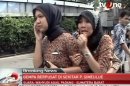 In this image made from Indonesian television TV One, two women react on a street shortly after they ran out from a building when a strong earthquake hit in Aceh in Indonesia, Wednesday, April 11, 2012. A tsunami watch was issued for countries across the Indian Ocean after a large earthquake hit waters off Indonesia on Wednesday, triggering widespread panic as residents along coastlines fled to high ground in cars and on the backs of motorcycles. (AP Photo/TV One via AP Video) INDONESIA OUT