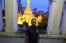 Toe Aung, deputy head of urban planning, poses for a photo at the Yangon City hall, with the lit Sule Pagoda seen behind him, in Yangon