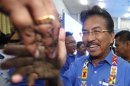 Malaysia's state of Sabah Chief Minister Musa Aman is greeted upon his arrival at his National Front coalition's pre-election campaign in Keningau