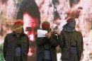 Masked supporters of jailed Kurdish rebel leader Abdullah Ocalan stand on the stage as one reads a statement during a gathering to celebrate Newroz in the southeastern Turkish city of Diyarbakir