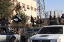 An image made available by Jihadist media outlet Welayat Raqa on June 30, 2014, allegedly shows a member of the Islamic state group parading in a street in the northern rebel-held Syrian city of Raqa