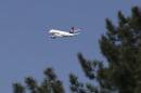 In this photo taken Wednesday, April 15, 2015, an Air Serbia passenger plane flies over Belgrade, Serbia. Serbia's authorities are investigating reports that a cargo package bound for the United States containing two missiles with explosive warheads was found on a passenger flight from Lebanon to Serbia. (AP Photo/Darko Vojinovic)