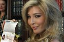 FILE - In this April 3, 2012, file photo, Jenna Talackova, who advanced to the finals of the Miss Canada competition, part of the Miss Universe contest, shows her passport that lists her gender as female, during a news conference in Los Angeles. Talackova says she was forced out of the competition because Pageant officials alleged she was not 
