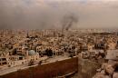 A general view taken from Aleppo's citadel show fumes rising following shelling on neighbourhoods in the old city on December 7, 2016