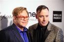 John and Furnish pose at the 2014 Elton John AIDS Foundation Oscar Party in West Hollywood