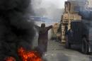 An Egyptian woman tries to stop a military bulldozer from going forward during clashes that broke out as Egyptian security forces moved in to disperse supporters of Egypt's deposed president Mohamed Morsi in a Cairo protest camp, August 14, 2013