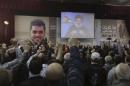 Lebanon's Hezbollah leader Sayyed Hassan Nasrallah addresses his supporters via a screen during a commemoration service marking one week since the killing of Hezbollah militant leader Samir Qantar, in Beirut's southern suburbs
