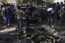Residents gather at the site of a car bomb explosion in Sadr City, northeastern Baghdad