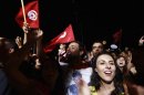 People waving Tunisian flags gather during a protest to demand the ouster of the Islamist-dominated government, outside the Constituent Assembly headquarters in Tunis