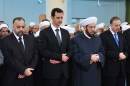 In this photo released by the Syrian official news agency SANA, Syrian President Bashar Assad, second left, prays during Eid al-Adha prayer at a mosque in Damascus, Syria, on Saturday Oct. 4, 2014. Assad has made a rare public appearance by attending prayers at a mosque in the capital, marking the beginning of the important Muslim holiday. (AP Photo/SANA)