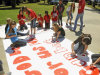 FILE - In this Sept. 19, 2012 file photo, Kountze High School cheerleaders and other children work on a large banner in Kountze, Texas. A judge on Wednesday, May 9, 2013 ruled that cheerleaders at the high school can display banners emblazoned with Bible verses at football games. The dispute began during the last football season when the district barred cheerleaders from using run-through banners that displayed religious messages, such as "If God is for us, who can be against us." (AP Photo/The Beaumont Enterprise, Dave Ryan, File)