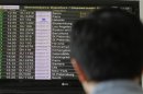 A man looks at a flight information board at Moscow's Sheremetyevo airport