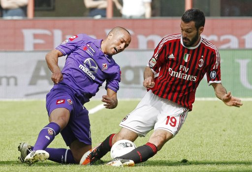 AC Milan's Zambrotta fights for the ball with Fiorentina's Kharja during their Italian Serie A soccer match in Milan