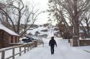 A member of an armed anti-government militia walks down a road on January 4, 2016 at the Malheur National Wildlife Refuge Headquarters near Burns, Oregon