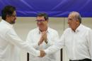 Colombia's FARC lead negotiator Ivan Marquez and Colombia's lead government negotiator Humberto de la Calle shake hands while Cuba's Foreign Minister Bruno Rodriguez looks on, after signing a final peace deal in Havana, Cuba