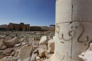 Graffiti (R) sprayed by Islamic State militants which reads "We remain" is seen at theTemple of Bel in historic city of Palmyra, in Homs Governorate, Syria April 1, 2016.