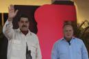 Venezuela's President Nicolas Maduro (L) waves next to Diosdado Cabello, deputy of Venezuela's United Socialist Party (PSUV), during the broadcast of his weekly TV program "Hitting with the Sledge Hammer" in Caracas