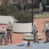 In this photo provided by John Fancher of the Tulsa City-County Library, sheriff's deputies surround a man who was wounded in an exchange of gunfire with law enforcement officers on the plaza in between the library and the Tulsa County Courthouse in Tulsa, Okla. on Wednesday, March 7, 2012. The shooter, a sheriff's deputy, and a bystander were wounded during the exchange, police said. (AP Photo/Tulsa City-County Library, John Fancher) MANDATORY CREDIT