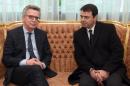 German Interior Minister Thomas de Maiziere (L) meets his Tunisian counterpart Hedi Majdoub (R) on March 1, 2016 in Tunis