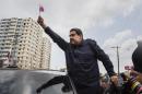 Venezuela's President Nicolas Maduro waves a miniature Panamanian flag from a car after attending a ceremony at a monument that honors the victims of the 1989 U.S. invasion, in the Chorrillo neighborhood, which saw the heaviest fighting during the invasion, in Panama City, Friday, April 10, 2015. A crowd of several hundred chanted in Spanish, "Maduro, stick it to the Yankee!" (AP Photo/Ramon Espinosa)