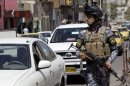 Iraqi police forces stand guard at a checkpoint in central Baghdad