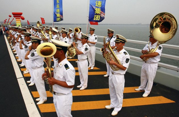 A band plays during the opening ceremony of the Qingdao Jiaozhou Bay Bridge in Qingdao