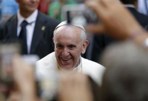 Pope Francis smiles as he arrives for a private visit at the Saint Agostino church in Rome