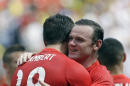 England's Rickie Lambert (18) is congratulated by teammate Wayne Rooney after Lambert scored a goal against Ecuador in the second half of a friendly soccer match in Miami Gardens, Fla., Wednesday, June 4, 2014. The game ended a 2-2 tie. (AP Photo/Alan Diaz)