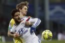 Lyon's Nabil Fekir, front, challenges for the ball with Nantes' Kian Hansen during their French League One soccer match in Lyon, central France, Sunday, Feb. 22, 2015. (AP Photo/Laurent Cipriani)