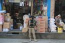 A policeman stands guard at a market in Mingora, in Swat Valley