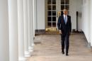 U.S. President Barack Obama walks down the colonnade from the Oval Office
