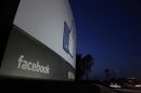 Traffic flies by the entrance sign to Facebook headquarters in Menlo Park before the company's IPO launch