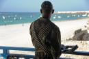 A Somali soldier looks at the Lido beach from the terrace of a restaurant on January 22, 2016
