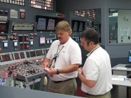FILE - In this March 30, 2011 file photo, nuclear reactor operators Chris Heinz, left, and Roger Patterson check steps that need to be taken as they practice an emergency scenario on a simulator of a digital control panel at Oconee Nuclear Station in Seneca , S.C. The nuclear plant will be the first in the U.S. to install an all-digital control panel for one of its reactors. (AP Photo/Jeffrey Collins/file)