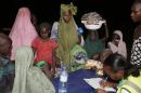 Women and children who were rescued by Nigerian soldiers from Boko Haram extremists at Sambisa Forest register their names upon their arrival at a refugee camp in Yola, Nigeria, Saturday May 2, 2015. They were among a group of 275 people rescued from Boko Haram extremists, the first to arrive at the refugee camp Saturday after a three-day journey to safety. Nigerian military said it has rescued more than 677 girls and women and destroyed more than a dozen insurgent camps in the past week. (AP Photo/Sunday Alamba)