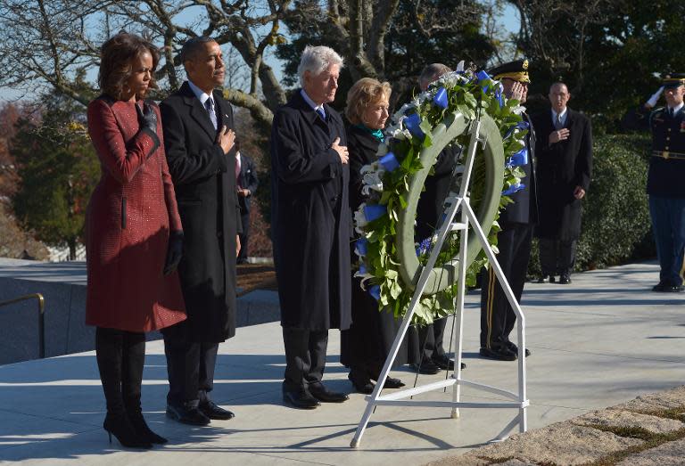 US President Barack Obama(2nd-L), First Lady Michelle Obama(L), former president Bill Clinton(3rd-L) and former secretary of state Hillary Clinton(4th-L) at the gravesite of late president John F. Kennedy on November 20, 2013 in Arlington, Virginia